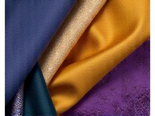 Various silk fabric swatches in rich, luxurious colors, arranged elegantly.